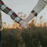two person holding hands while standing